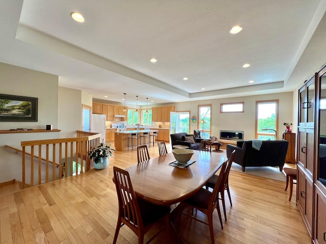 2774 Pine Ridge Blvd, Red Wing, MN 55066 - dining room featuring a raised ceiling, recessed lighting, light wood-style floors, and baseboards