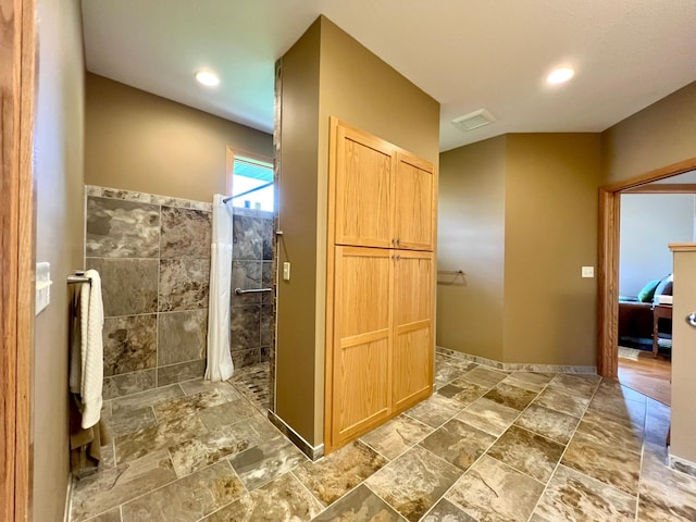 2774 Pine Ridge Blvd, Red Wing, MN 55066 - ensuite bathroom featuring a walk in shower, stone finish flooring, and recessed lighting