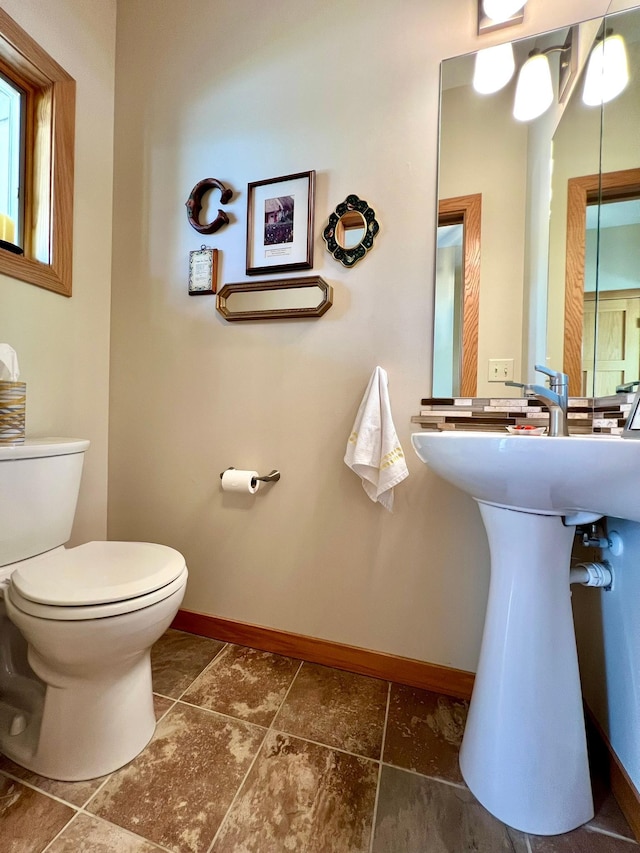 2774 Pine Ridge Blvd, Red Wing, MN 55066 - half bathroom with toilet, baseboards, a sink, and tile patterned flooring