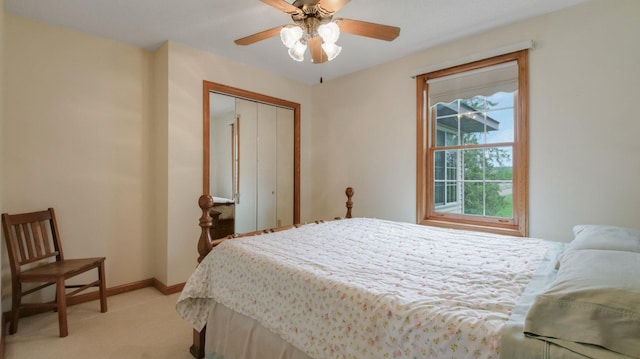 9020 120th Ave, Tilden Twp, WI 54724 - bedroom featuring light carpet, a closet, baseboards, and a ceiling fan