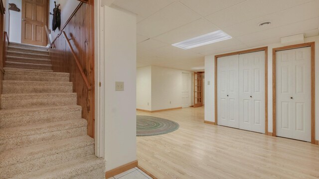 9020 120th Ave, Tilden Twp, WI 54724 - staircase featuring baseboards, wood finished floors, and a drop ceiling