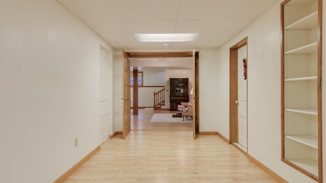 9020 120th Ave, Tilden Twp, WI 54724 - hall featuring light wood finished floors, a drop ceiling, and baseboards