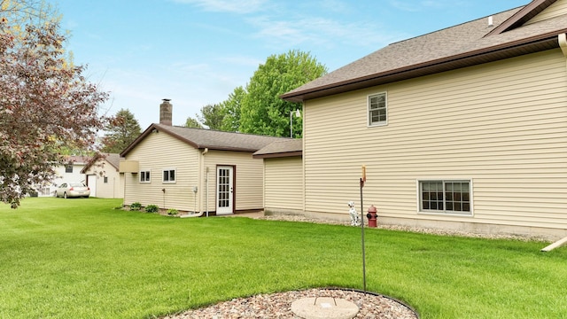 9020 120th Ave, Tilden Twp, WI 54724 - rear view of property with a yard, a chimney, and roof with shingles