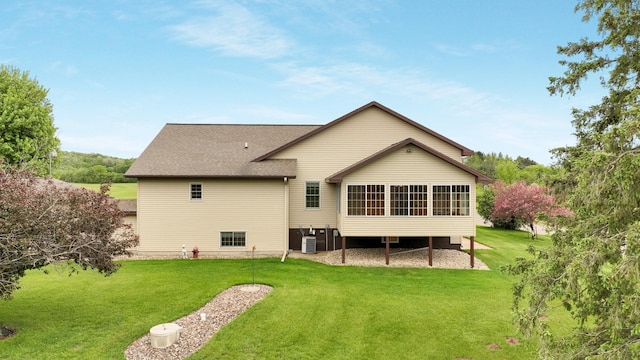 9020 120th Ave, Tilden Twp, WI 54724 - rear view of house with central AC unit, a yard, a sunroom, and roof with shingles