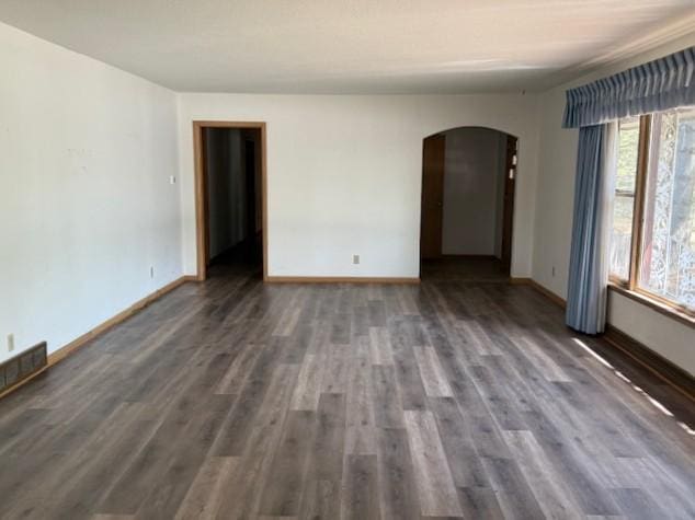 510 2nd Ave NW, Milaca, MN 56353 - unfurnished room with arched walkways, wood finished floors, and baseboards