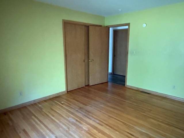 510 2nd Ave NW, Milaca, MN 56353 - unfurnished bedroom with light wood-type flooring, baseboards, and a closet