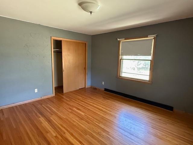 510 2nd Ave NW, Milaca, MN 56353 - unfurnished bedroom with a closet, wood finished floors, and baseboards