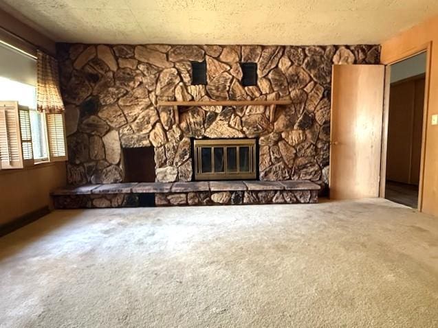 510 2nd Ave NW, Milaca, MN 56353 - unfurnished living room featuring a stone fireplace and carpet flooring