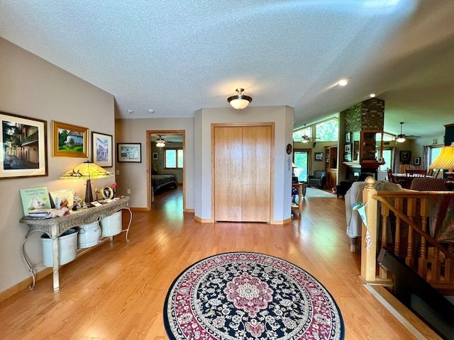 964 Aurora Cir, Red Wing, MN 55066 - entryway featuring a ceiling fan, wood finished floors, a textured ceiling, baseboards, and vaulted ceiling
