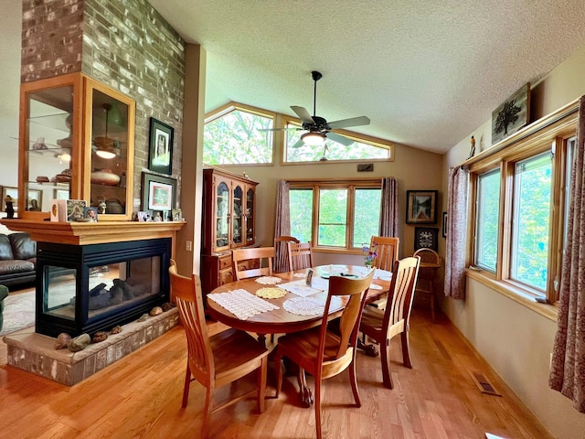 964 Aurora Cir, Red Wing, MN 55066 - dining space featuring ceiling fan, light wood finished floors, a textured ceiling, lofted ceiling, and healthy amount of natural light