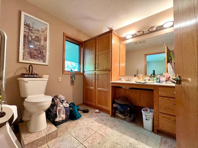 964 Aurora Cir, Red Wing, MN 55066 - bathroom featuring vanity, tile patterned floors, toilet, and a textured ceiling