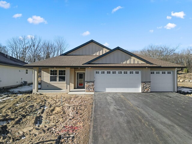 1957 Woods Pt, Waconia, MN 55387 - view of front of property featuring board and batten siding, asphalt driveway, a garage, and roof with shingles