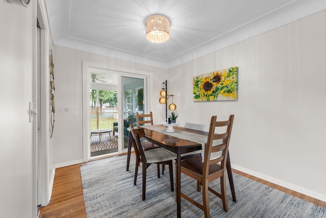 4065 Jersey Ave N, Crystal, MN 55427 - dining space with wood finished floors, a chandelier, and ceiling fan