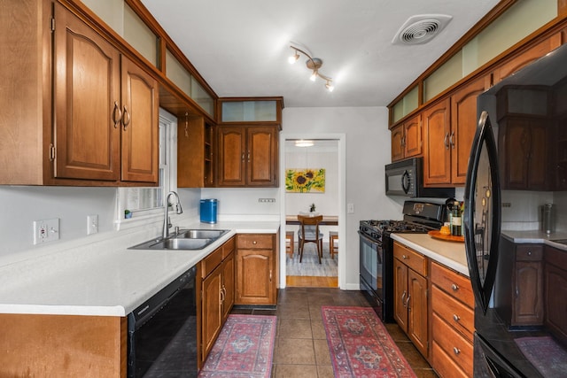 4065 Jersey Ave N, Crystal, MN 55427 - kitchen featuring black appliances, brown cabinetry, light countertops, and dark tile patterned flooring