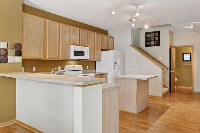 18571 98th Ave N, Maple Grove, MN 55311 - kitchen featuring white appliances, light brown cabinetry, light wood-style floors, a peninsula, and a textured ceiling