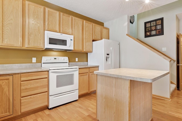 18571 98th Ave N, Maple Grove, MN 55311 - kitchen featuring white appliances, light brown cabinets, light wood-style flooring, light countertops, and a textured ceiling