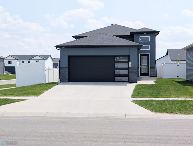 1506 67th Ave S, Fargo, ND 58104 - view of front of property with an attached garage, driveway, roof with shingles, and brick siding