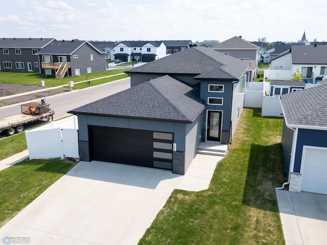 1506 67th Ave S, Fargo, ND 58104 - view of front of house featuring a residential view, a shingled roof, an attached garage, and driveway