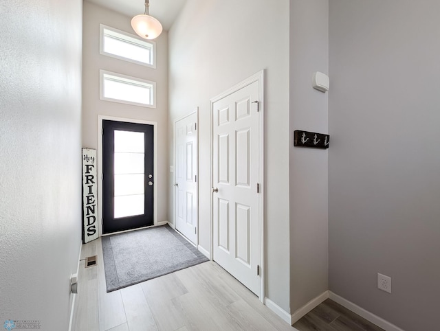 1506 67th Ave S, Fargo, ND 58104 - entrance foyer with wood finished floors, a towering ceiling, and baseboards