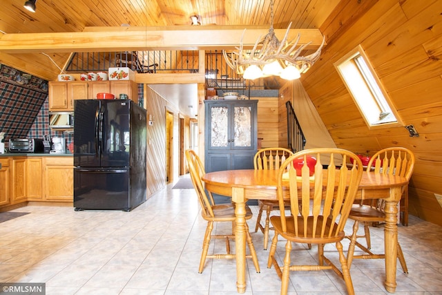 66893 185th Pl, Jacobson, MN 55752 - dining area featuring wood ceiling, a skylight, a chandelier, and wooden walls