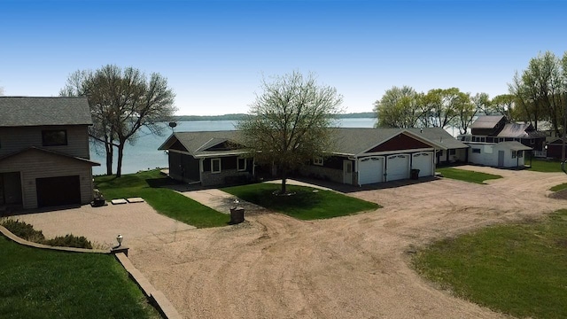 25797 Silver Beach Rd, Minnewaska Twp, MN 56334 - view of front facade with dirt driveway, an attached garage, a water view, and a front yard