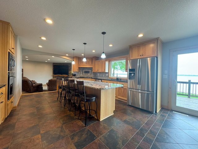 25797 Silver Beach Rd, Minnewaska Twp, MN 56334 - kitchen with stainless steel appliances, open floor plan, recessed lighting, a breakfast bar, and a sink