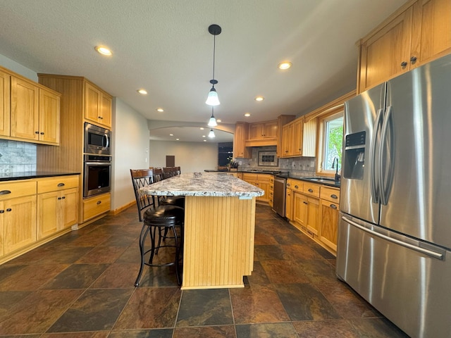 25797 Silver Beach Rd, Minnewaska Twp, MN 56334 - kitchen with appliances with stainless steel finishes, decorative backsplash, recessed lighting, a sink, and stone tile floors