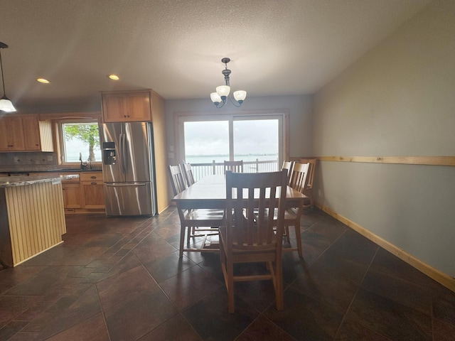25797 Silver Beach Rd, Minnewaska Twp, MN 56334 - dining area featuring a chandelier, baseboards, and recessed lighting