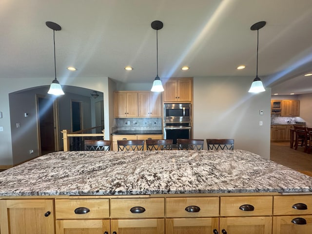 25797 Silver Beach Rd, Minnewaska Twp, MN 56334 - kitchen featuring stainless steel appliances, a center island, light brown cabinetry, tasteful backsplash, and recessed lighting