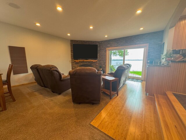 25797 Silver Beach Rd, Minnewaska Twp, MN 56334 - home theater room featuring recessed lighting, a fireplace, and light wood finished floors