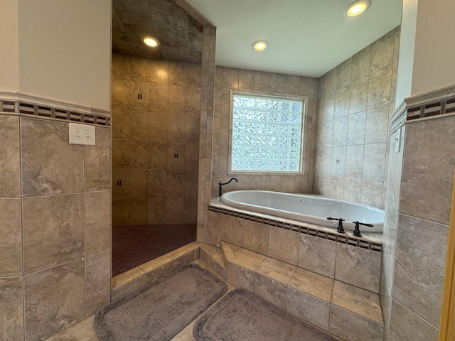 25797 Silver Beach Rd, Minnewaska Twp, MN 56334 - bathroom with tile walls, a bath, a tile shower, and recessed lighting