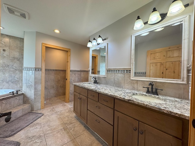 25797 Silver Beach Rd, Minnewaska Twp, MN 56334 - full bath with tile walls, a bath, double vanity, a wainscoted wall, and tile patterned floors