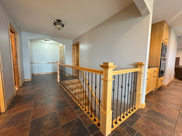 25797 Silver Beach Rd, Minnewaska Twp, MN 56334 - hall with stone tile floors, arched walkways, and baseboards