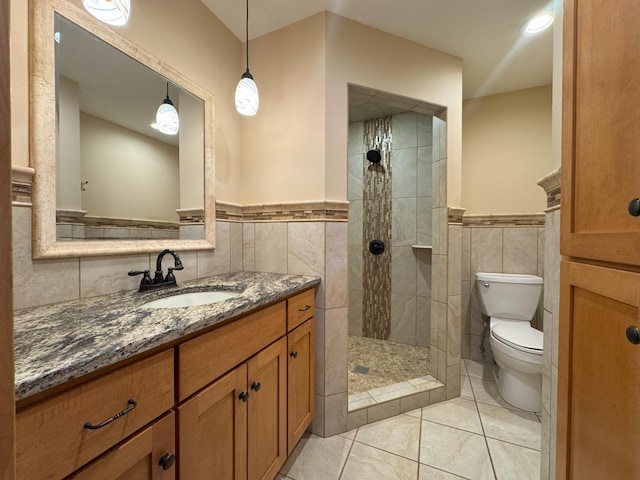 25797 Silver Beach Rd, Minnewaska Twp, MN 56334 - bathroom with tile walls, toilet, vanity, a walk in shower, and wainscoting