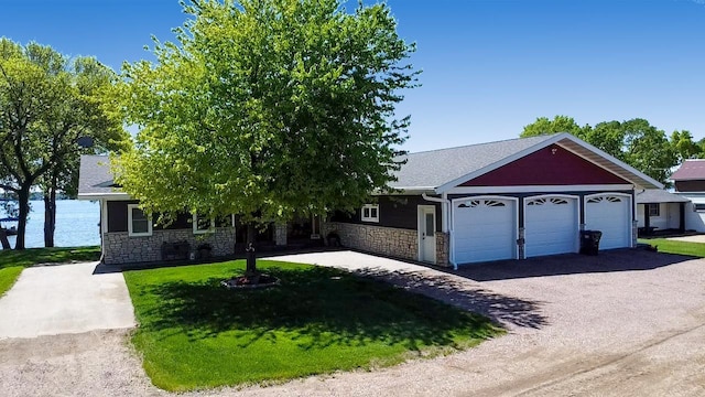 25797 Silver Beach Rd, Minnewaska Twp, MN 56334 - view of front facade with stone siding, a garage, asphalt driveway, and a front yard