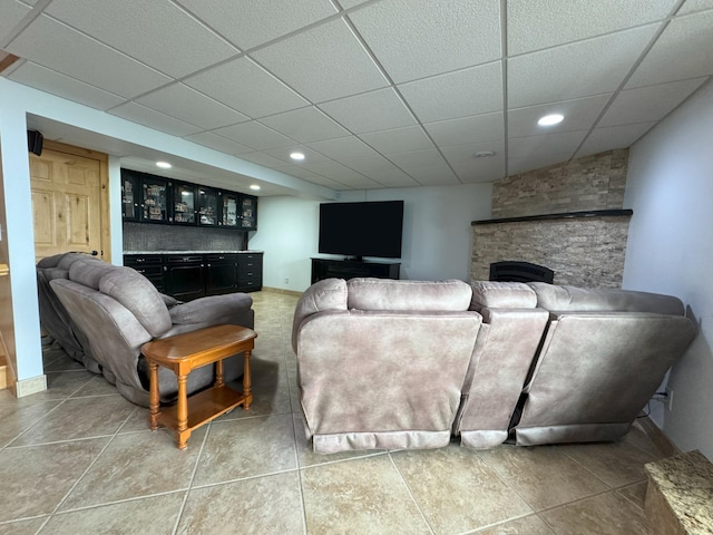 25797 Silver Beach Rd, Minnewaska Twp, MN 56334 - tiled living room with a stone fireplace, a paneled ceiling, recessed lighting, and bar area