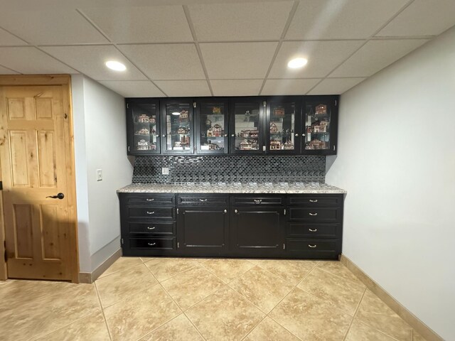 25797 Silver Beach Rd, Minnewaska Twp, MN 56334 - bar area featuring a paneled ceiling, backsplash, light tile patterned floors, and baseboards