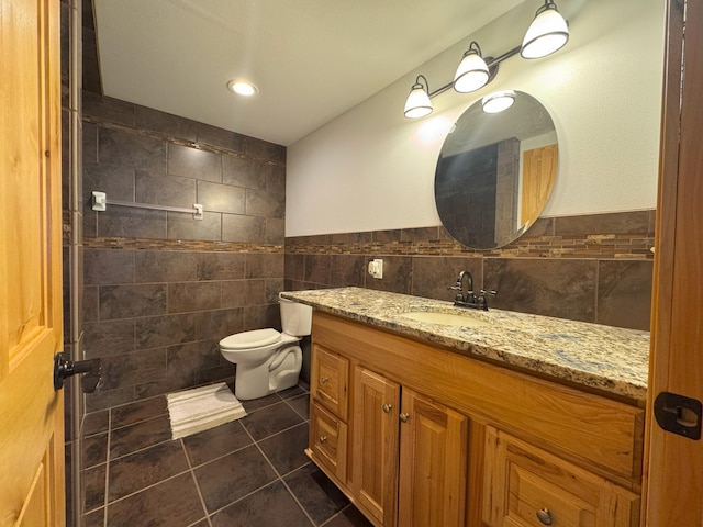 25797 Silver Beach Rd, Minnewaska Twp, MN 56334 - bathroom with tile walls, vanity, tile patterned flooring, and toilet