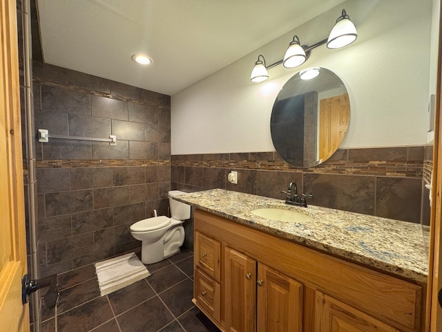 25797 Silver Beach Rd, Minnewaska Twp, MN 56334 - bathroom featuring tile walls, vanity, tile patterned floors, and toilet