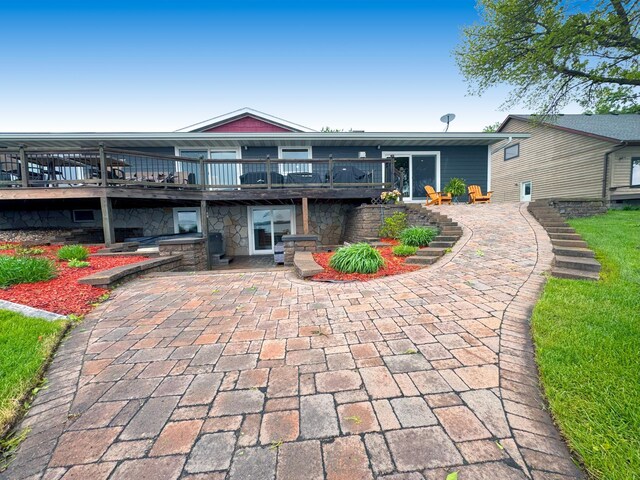 25797 Silver Beach Rd, Minnewaska Twp, MN 56334 - rear view of house featuring a patio area, a deck, and stone siding