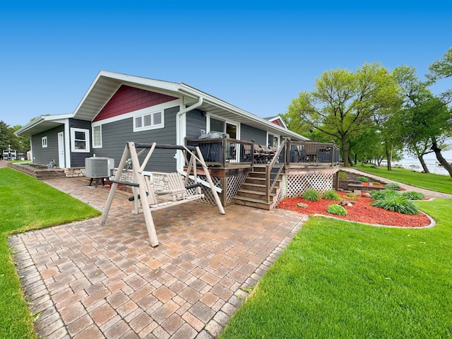 25797 Silver Beach Rd, Minnewaska Twp, MN 56334 - rear view of property featuring a deck, a patio area, a yard, and central air condition unit