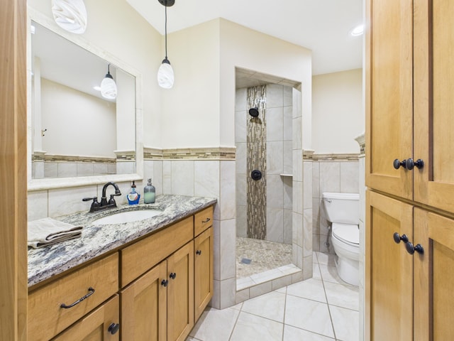 25797 Silver Beach Rd, Minnewaska Twp, MN 56334 - bathroom featuring tile walls, vanity, a tile shower, tile patterned floors, and wainscoting