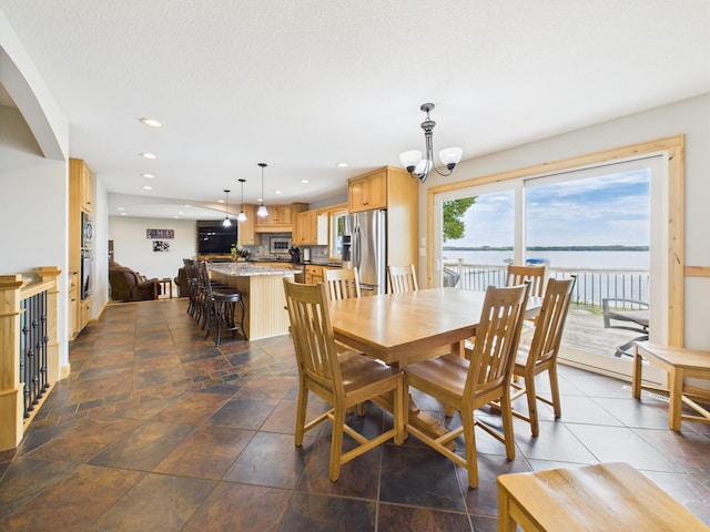 25797 Silver Beach Rd, Minnewaska Twp, MN 56334 - dining room featuring a chandelier, recessed lighting, and a water view