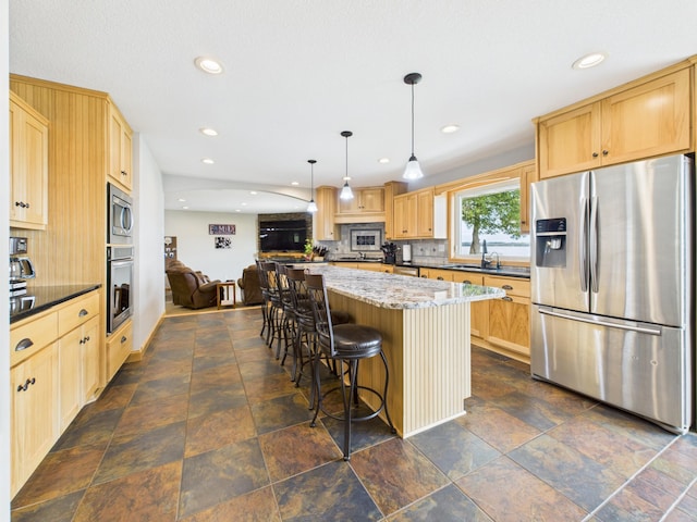 25797 Silver Beach Rd, Minnewaska Twp, MN 56334 - kitchen featuring appliances with stainless steel finishes, light brown cabinets, dark stone finish floors, a center island, and recessed lighting