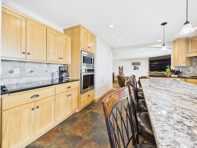 25797 Silver Beach Rd, Minnewaska Twp, MN 56334 - kitchen featuring appliances with stainless steel finishes, light brown cabinetry, backsplash, a breakfast bar area, and recessed lighting