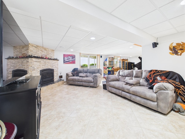 25797 Silver Beach Rd, Minnewaska Twp, MN 56334 - living area featuring a paneled ceiling, light tile patterned floors, and a stone fireplace