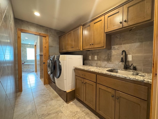25797 Silver Beach Rd, Minnewaska Twp, MN 56334 - laundry area with tile walls, independent washer and dryer, cabinet space, and light tile patterned flooring