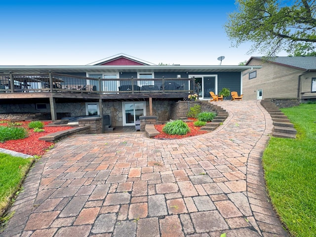25797 Silver Beach Rd, Minnewaska Twp, MN 56334 - back of house with a patio, a wooden deck, and stone siding