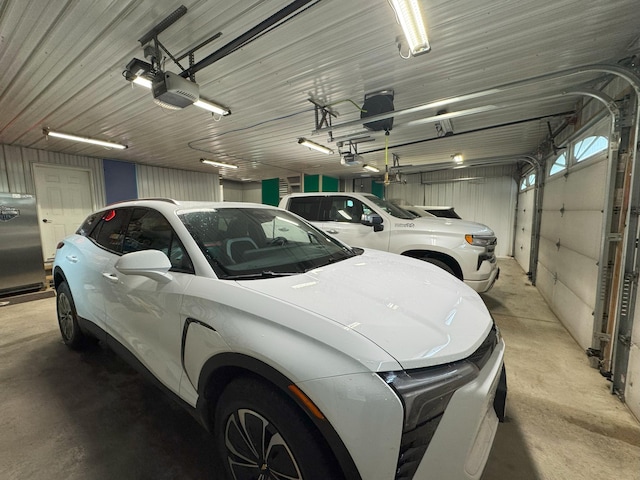 25797 Silver Beach Rd, Minnewaska Twp, MN 56334 - garage with a garage door opener and stainless steel fridge