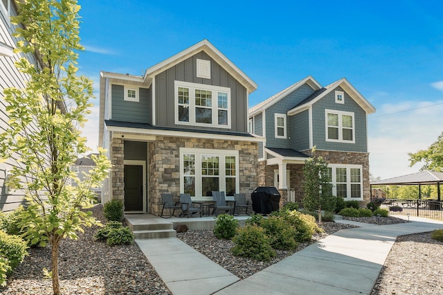 3011 Rum River Way, Anoka, MN 55303 - craftsman inspired home featuring stone siding, a porch, a gazebo, and board and batten siding